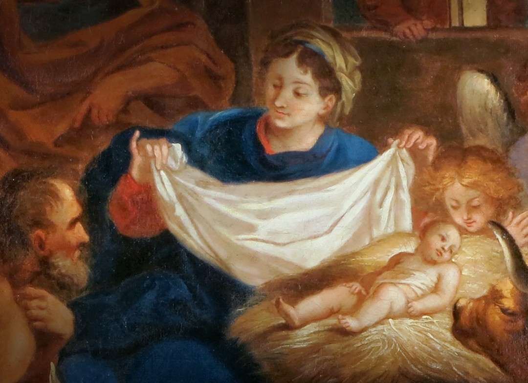 Maria Faltet ein weißes Tuch neben der Grippe in der Jesus als Baby liegt. Josef, ein Ochse und ein Engel schauen auf den kleinen Jesus.
